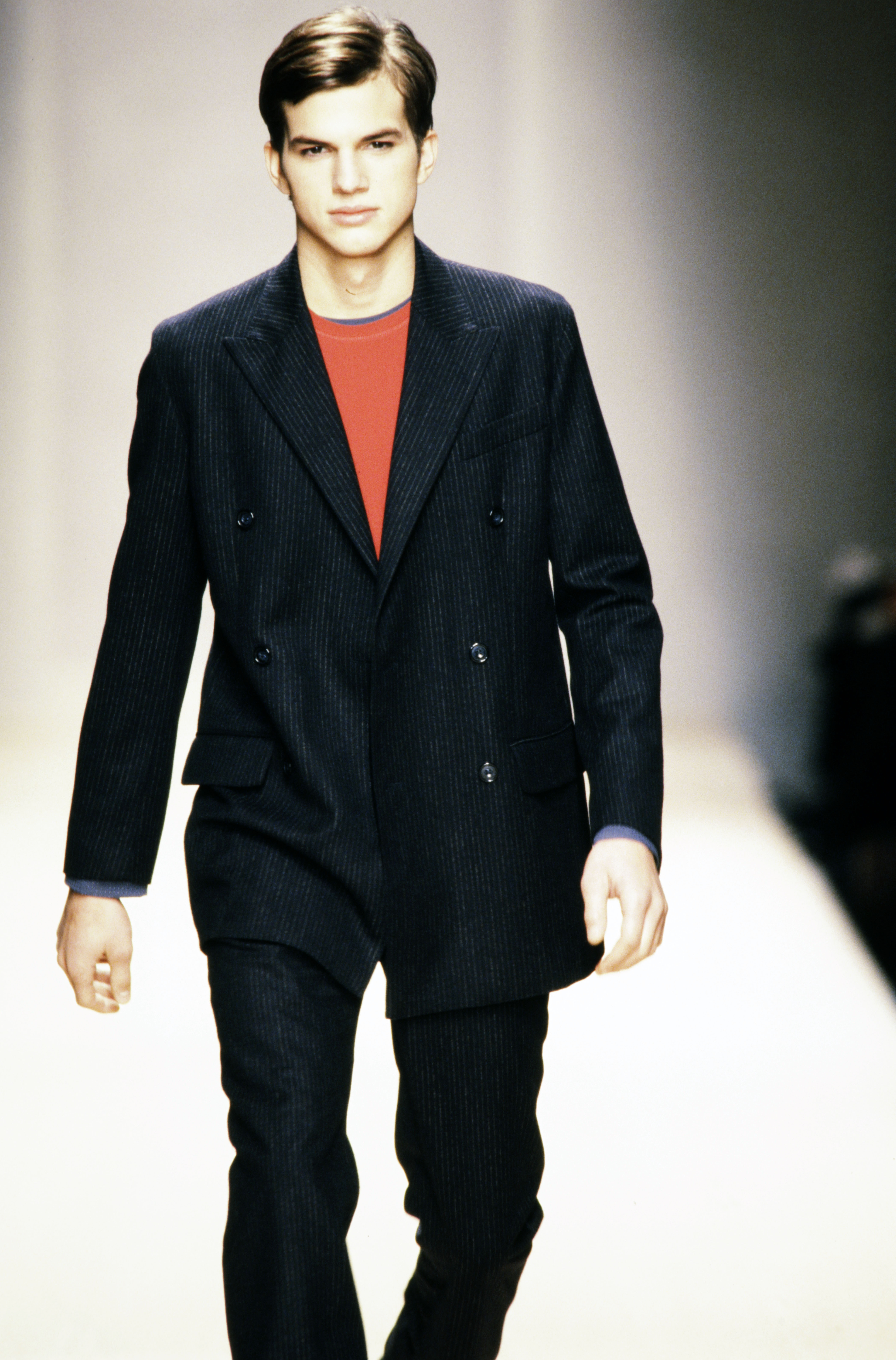 Ashton Kutcher walking in the Byblos Spring 1998 Men's Ready to Wear Collection Runway Show. | Source: Getty Images