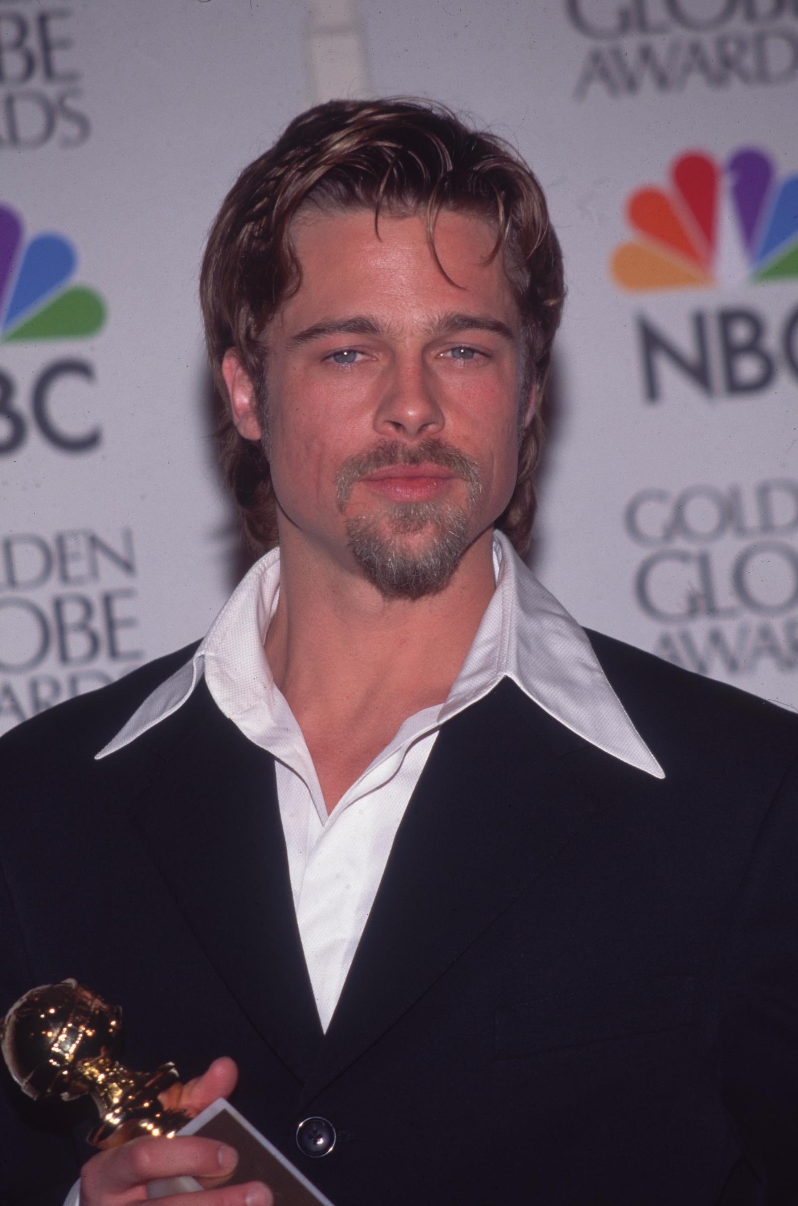 Brad Pitt holding his Golden Globe Award for Best Supporting Actor on January 1, 1996, in  Los Angeles, California. | Source: Getty Images